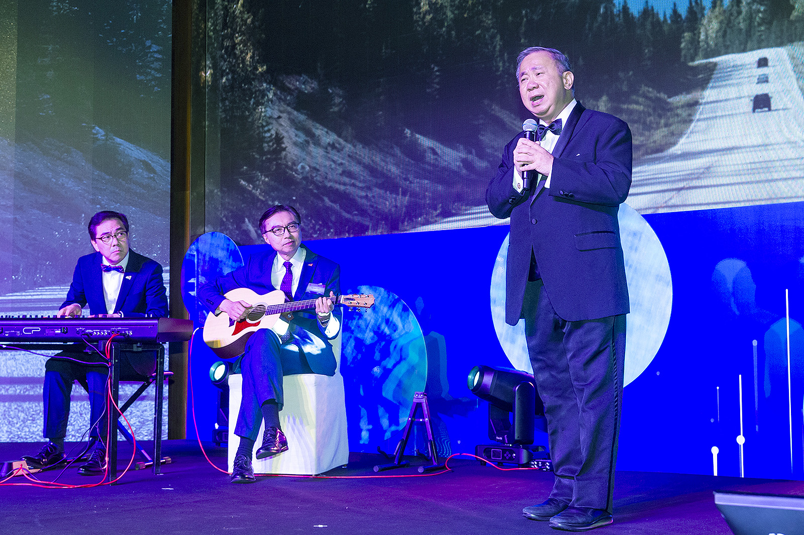 The audience is captivated by President Boey's extraordinary singing prowess.