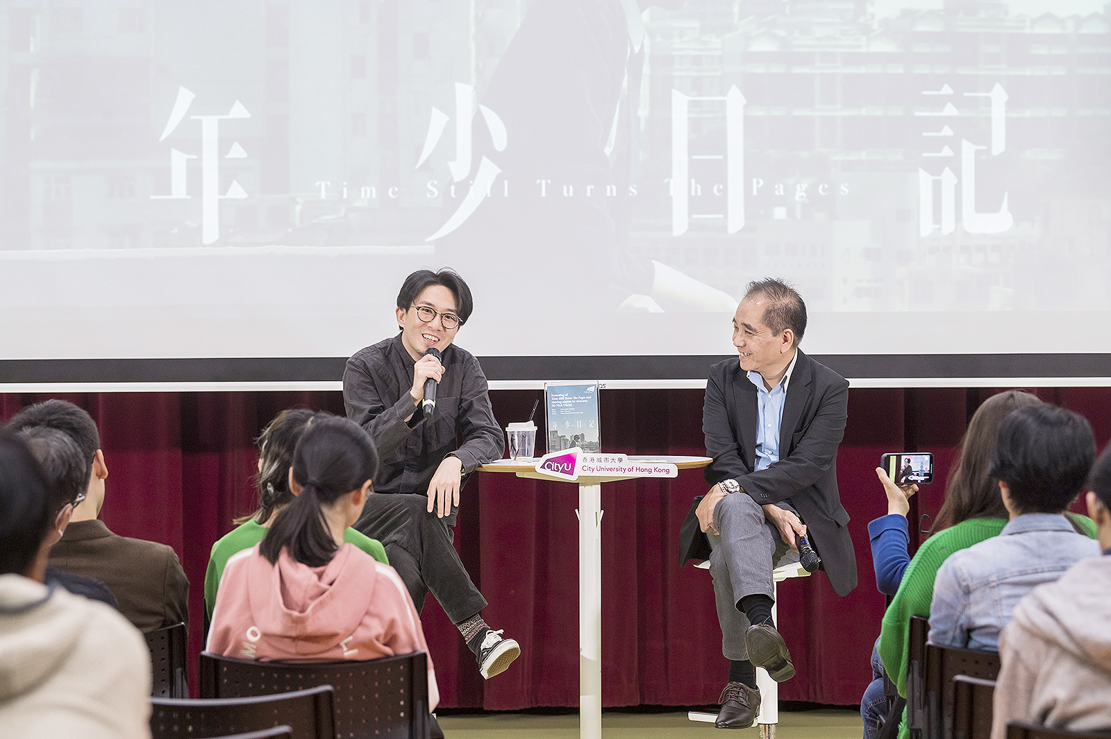 Mr Cheuk (left) shares details of shooting Time Still Turns The Pages and answers questions from Dr Ng and the students in detail.