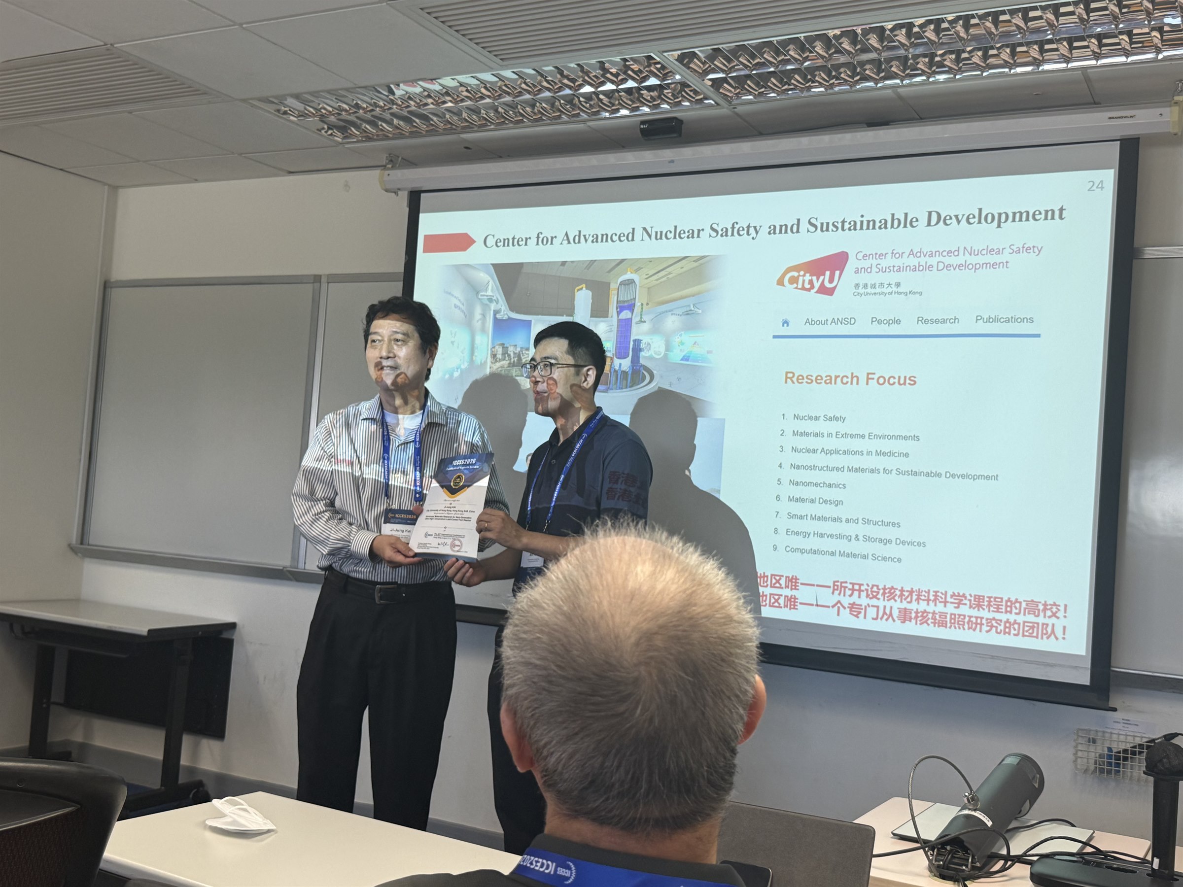 ANSD representative holding a conference certificate during ICCES 2026 in Hong Kong