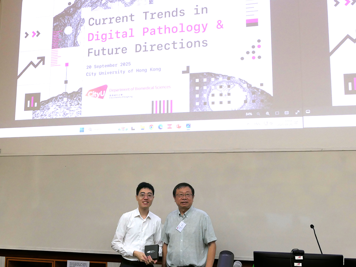 Prof. Yu Huang presents a BMS souvenir to guest speaker Prof. Hei Ming Lai.