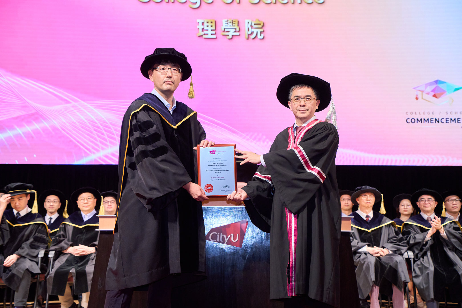 Prof. Chenchen Mou (left) received the College of Science Outstanding Young Researcher Award from CSCI Dean Prof. Xin Wang (right). 