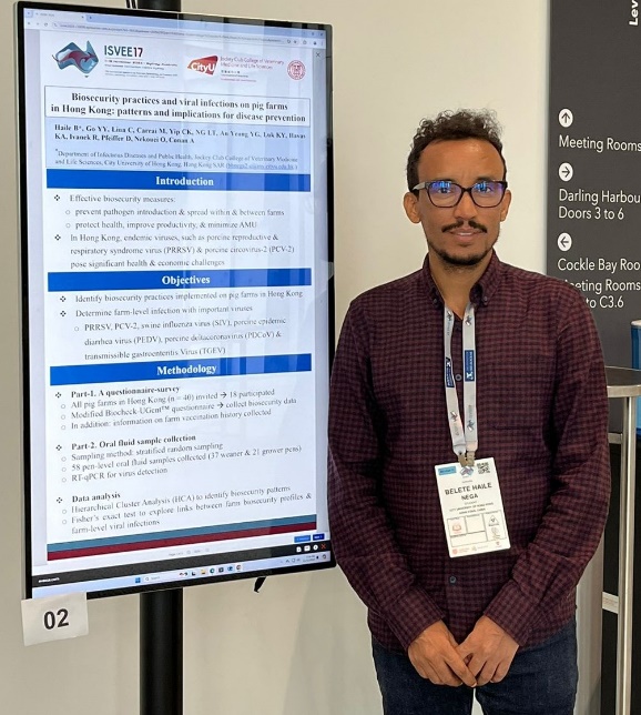 A person standing in front of a large screen
Description automatically generated