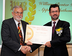 Mr William Benter (right) presents the first William Benter Prize in Applied Mathematics to Professor George Papanicolaou.