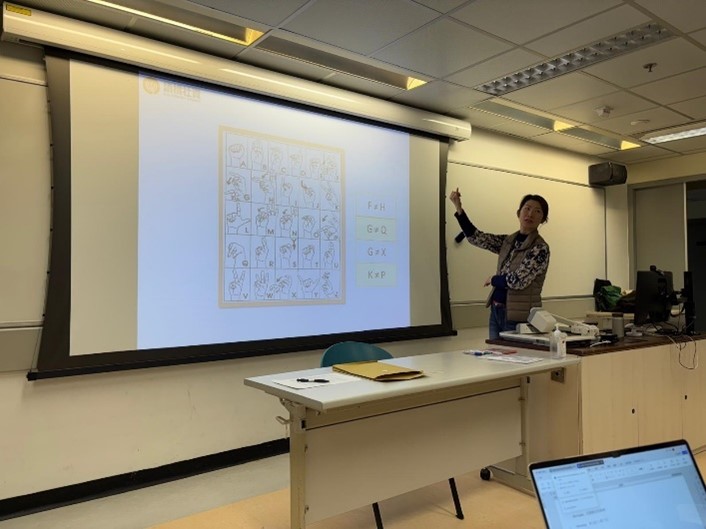 The deaf instructor was demonstrating sign language for the English alphabet.