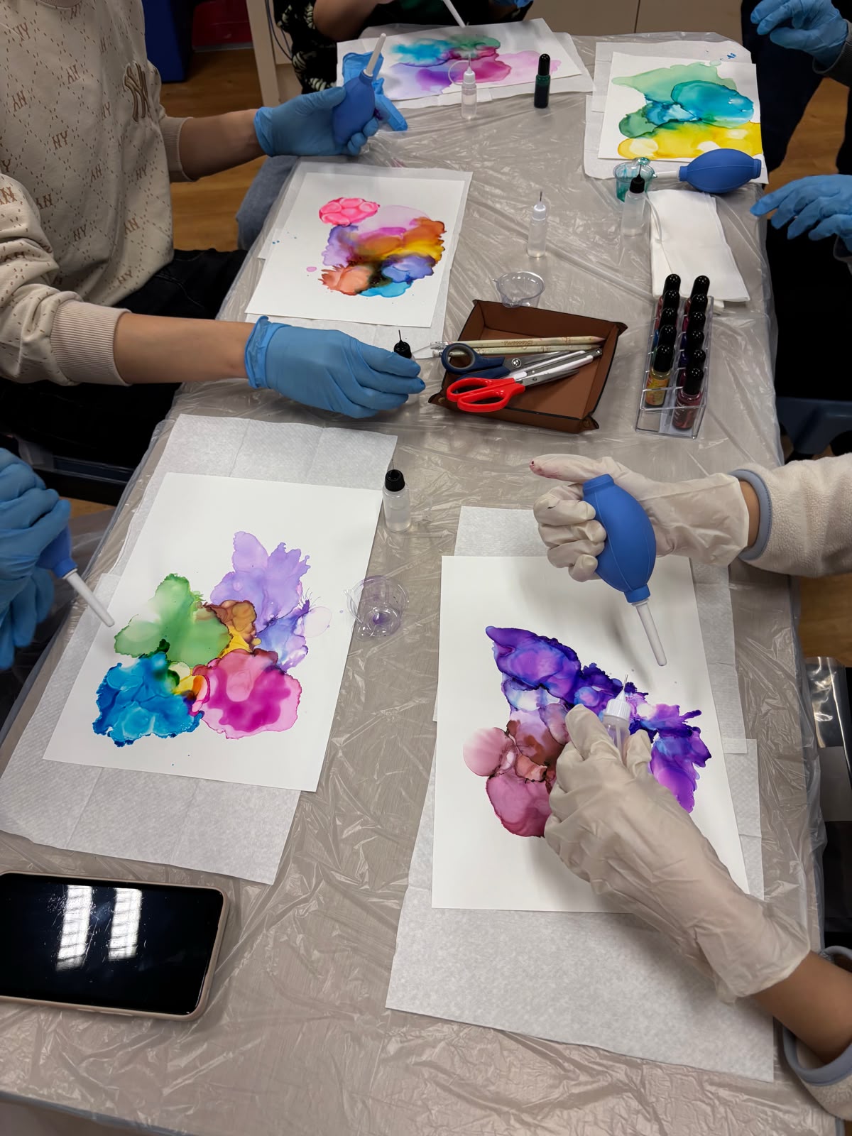 The students are creating alcohol ink paintings.