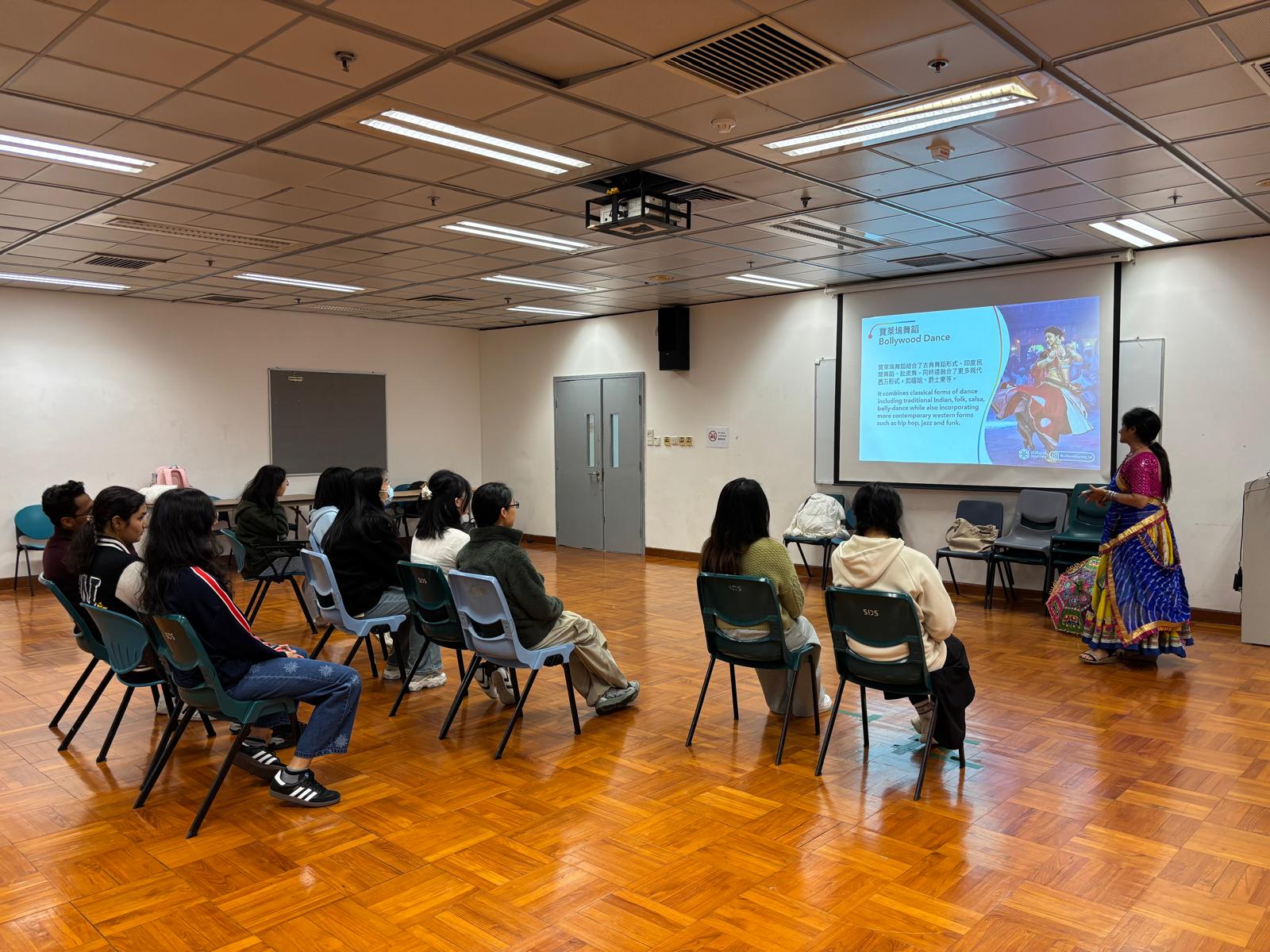 The dance teacher was introducing the background and history of Bollywood dance.