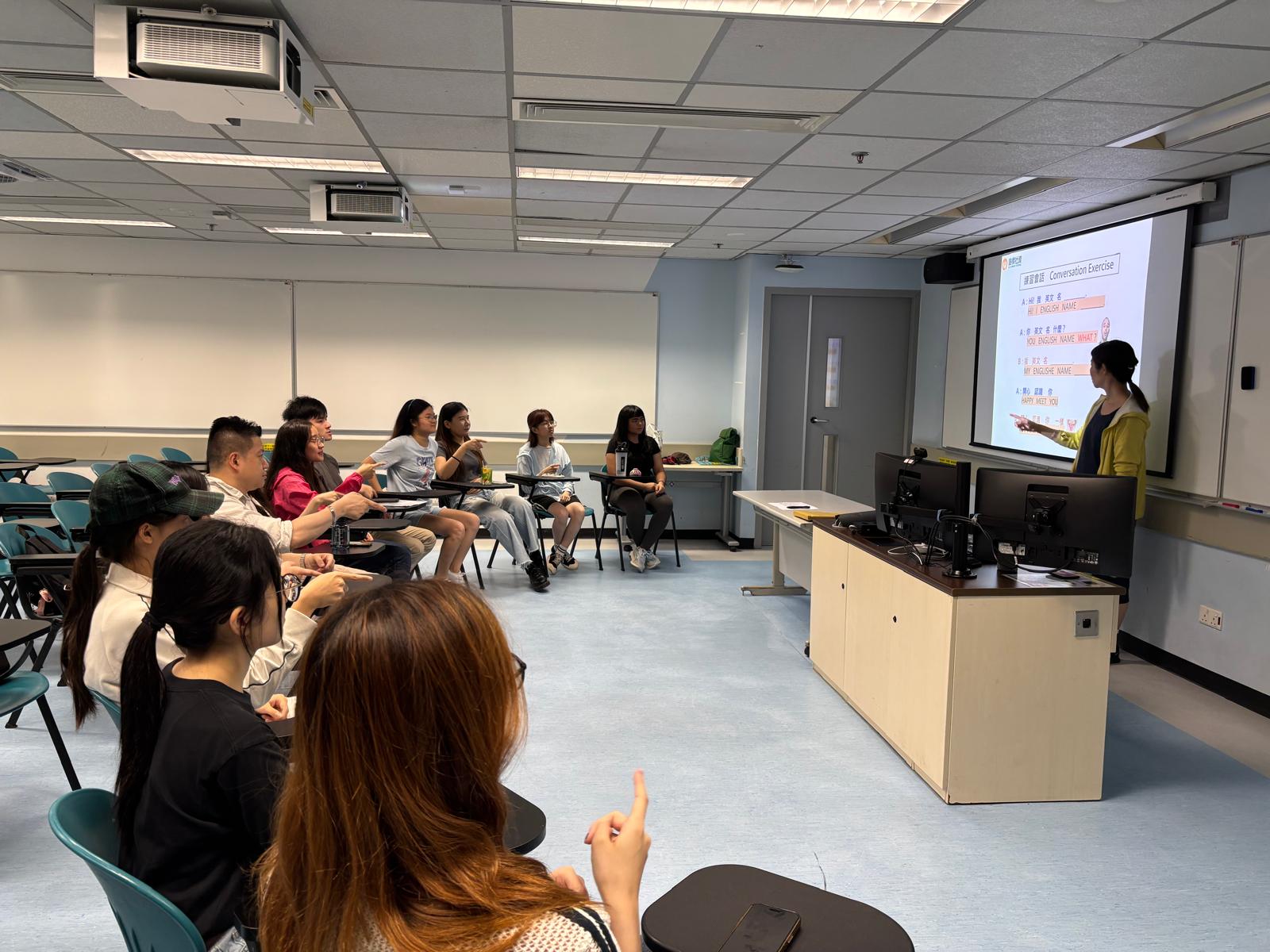 The deaf teacher was teaching sign language for basic conversation.