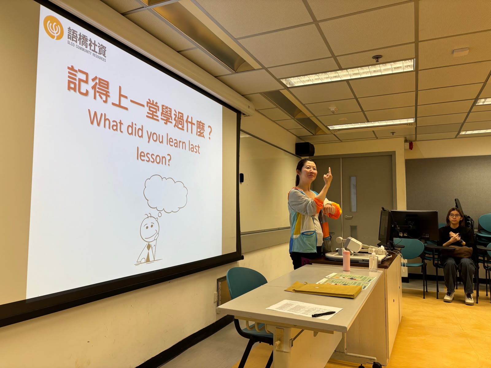 The deaf teacher was reviewing the sign language knowledge from the last lesson.