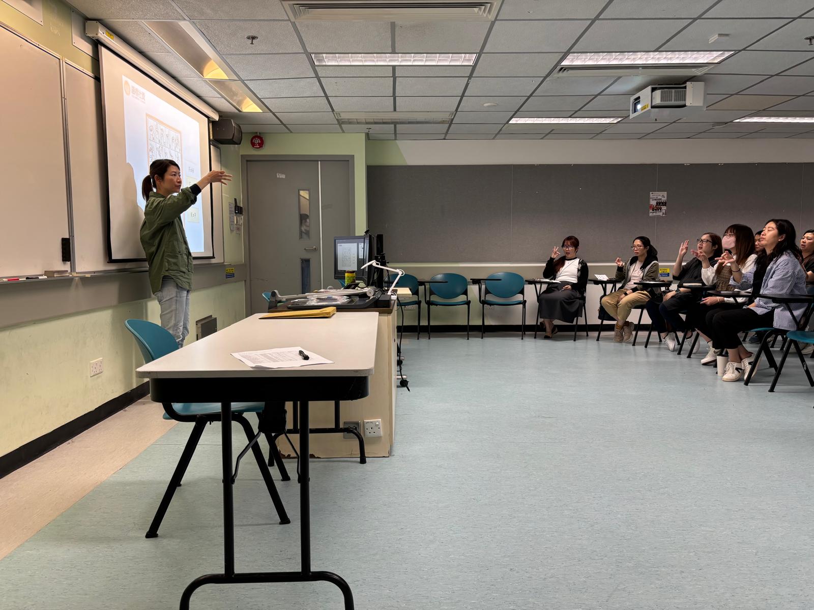 The deaf instructor was demonstrating the sign language for the English alphabet.