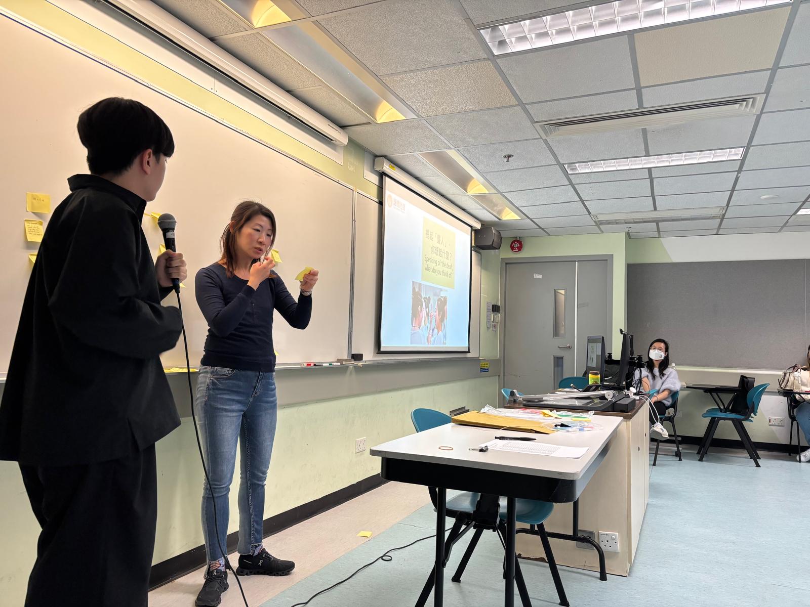 The deaf instructor was learning about the staff's impressions and views of deaf individuals.