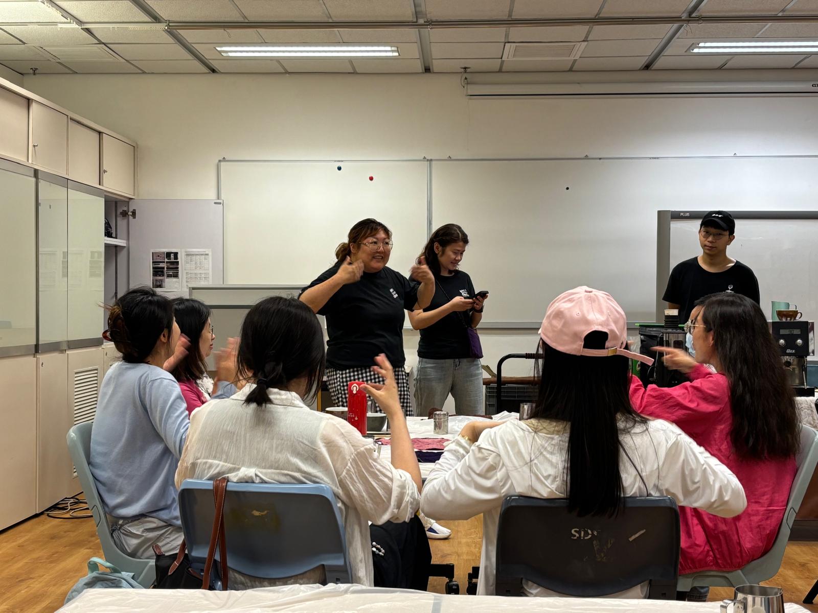 The founder of the organization and the deaf barista were teaching sign language.