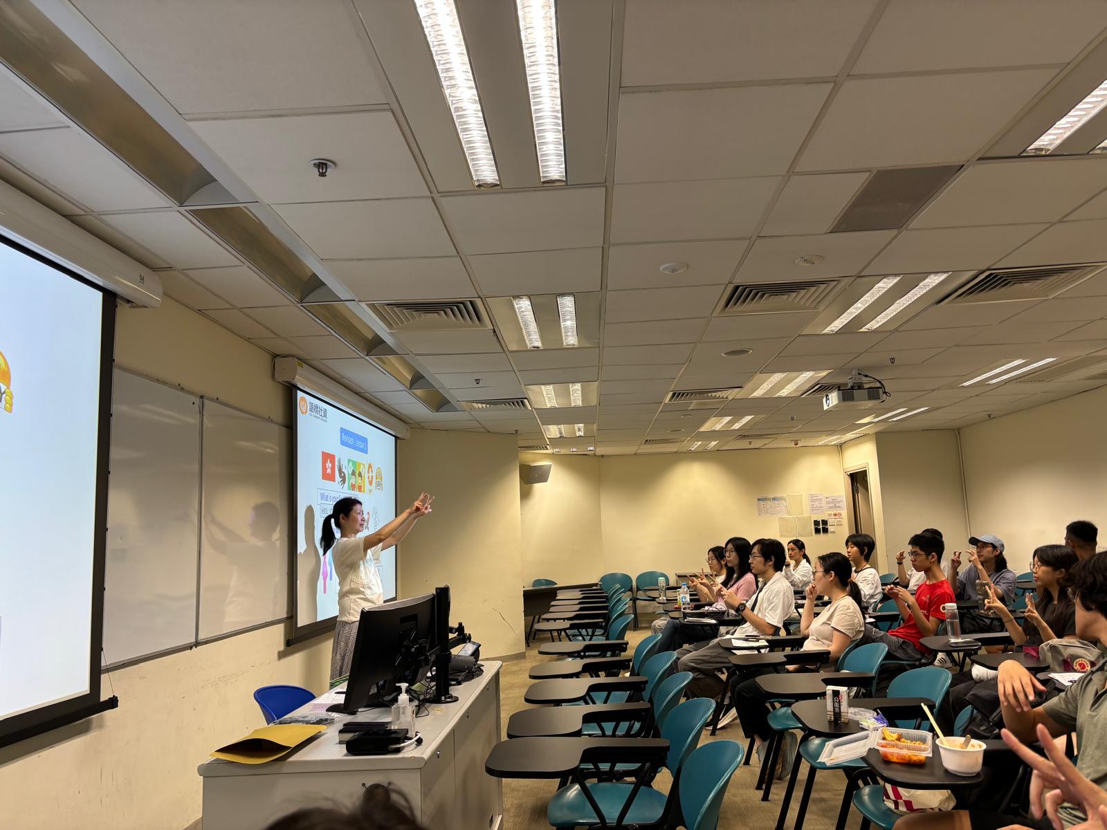 The Deaf instructor was demonstrating the sign language for daily expressions.