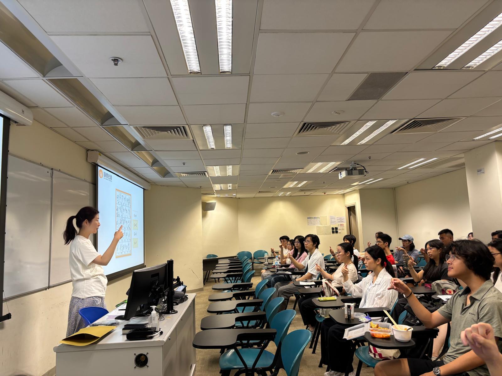 The Deaf instructor was demonstrating the sign language for the English alphabet.