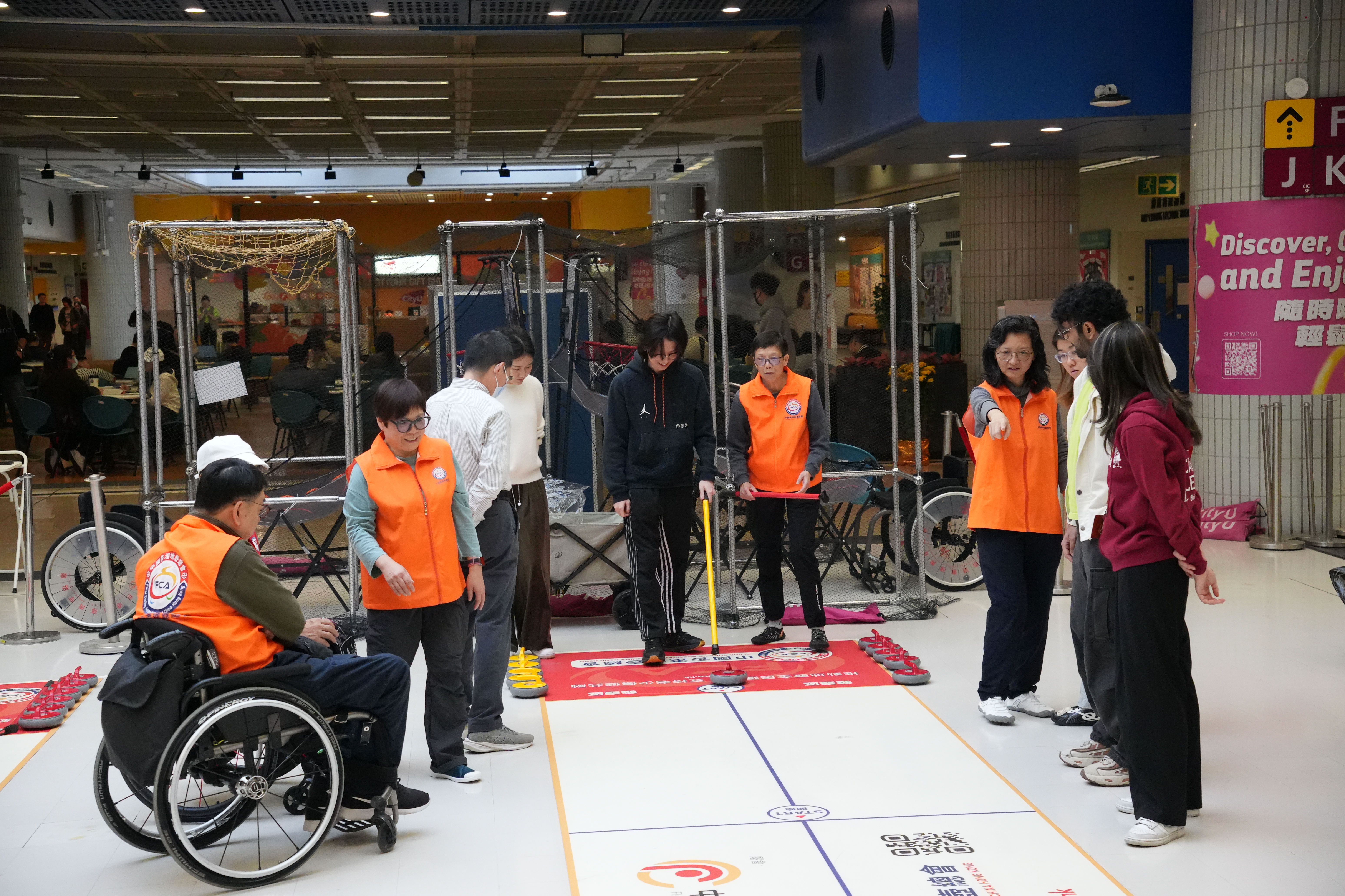 The instructors were teaching the students how to play floor curling.