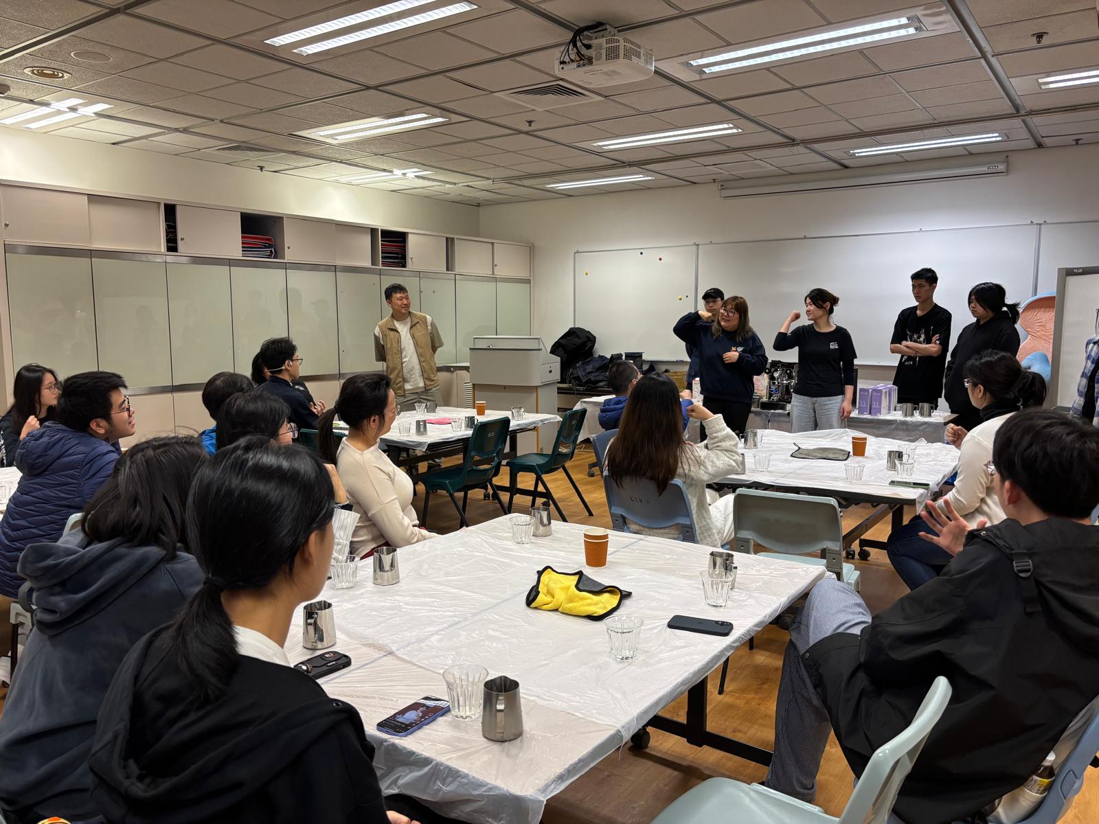 The instructor was teaching sign language for different beverages.