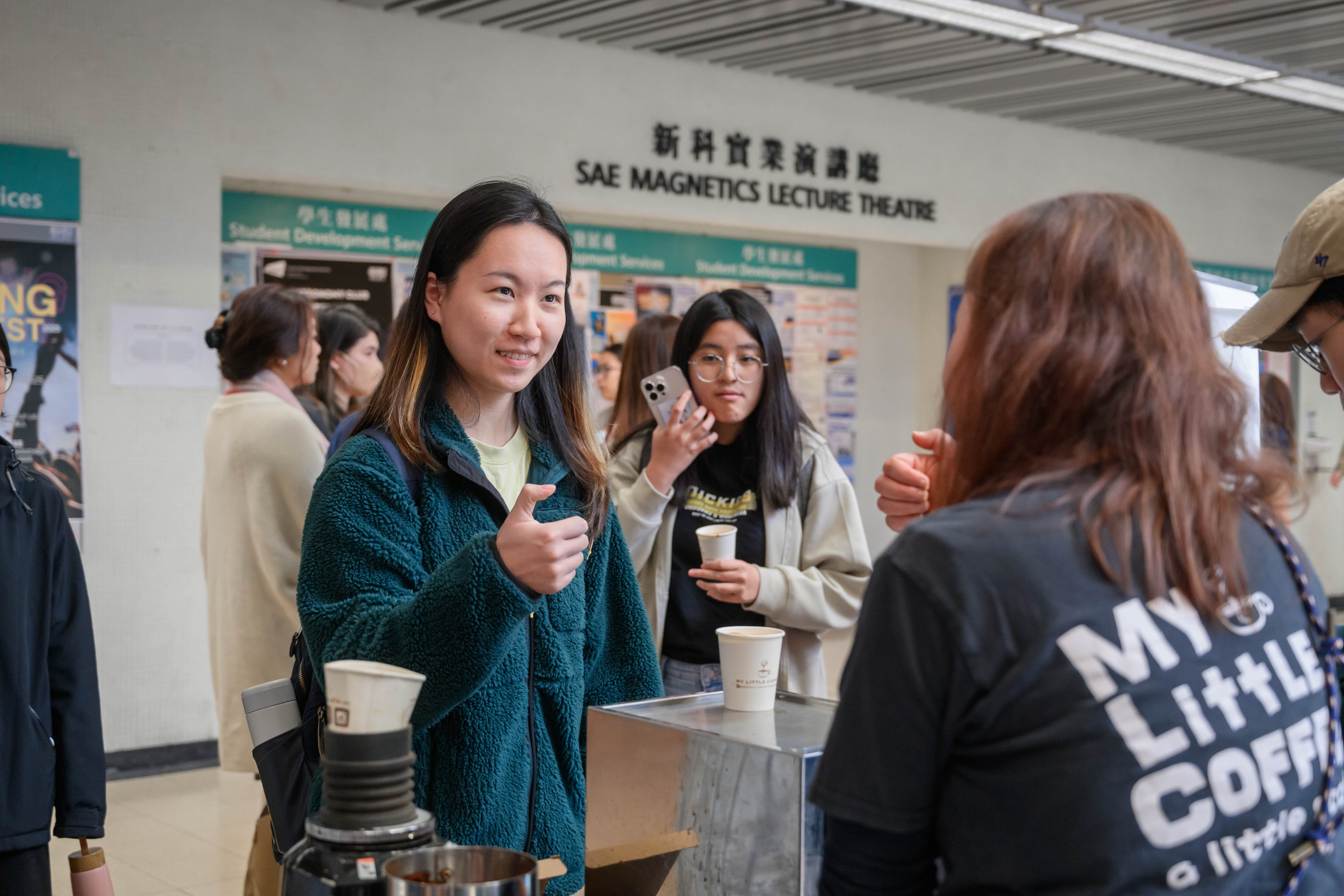 The students were queuing up to collect their sign language coffee.