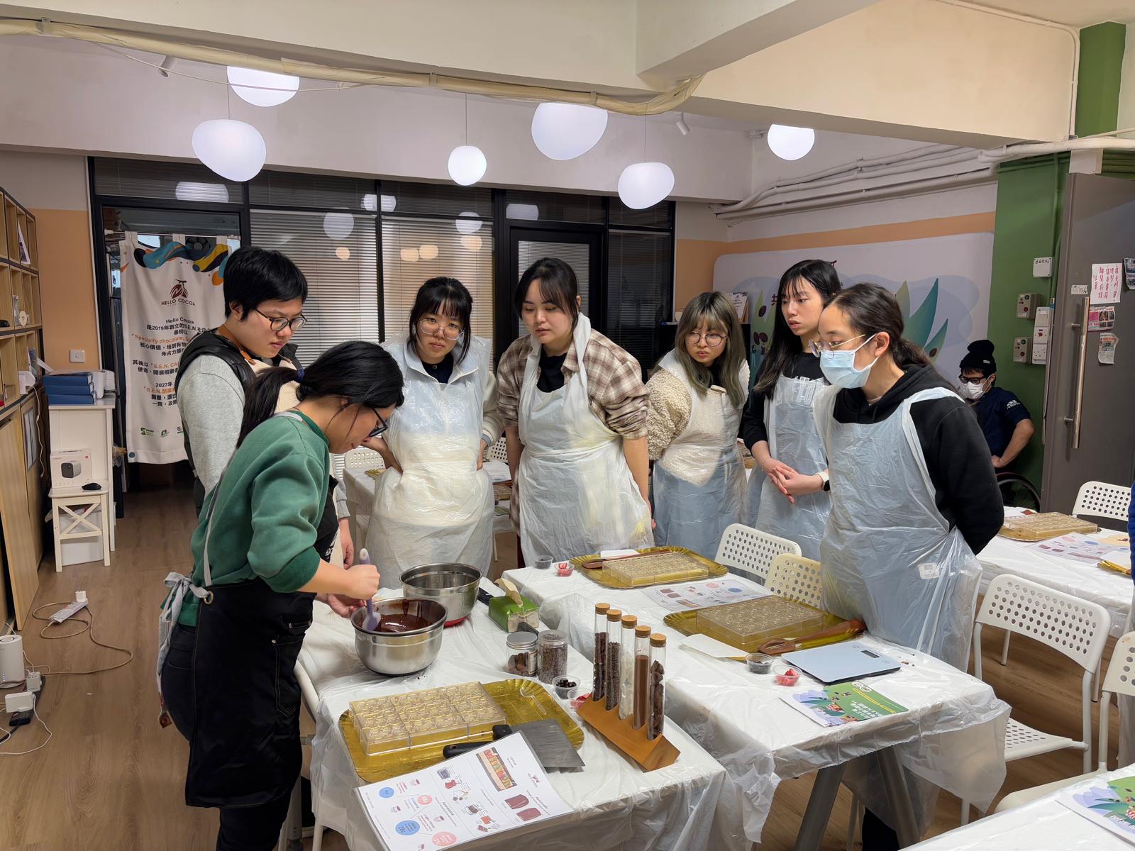 The staff of the organization was demonstrating how to make chocolate.