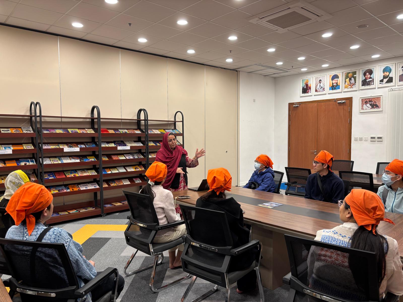 The guide was introducing the background of Sikhism.