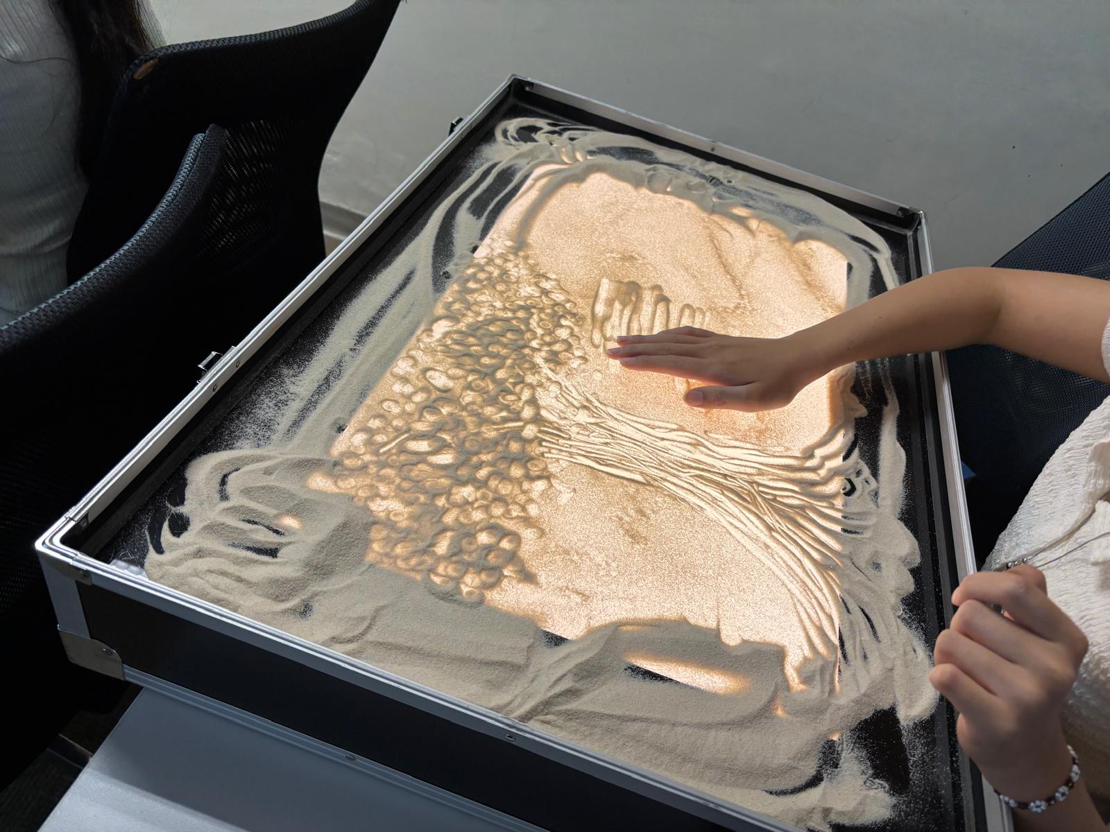 The student was practicing sand art.