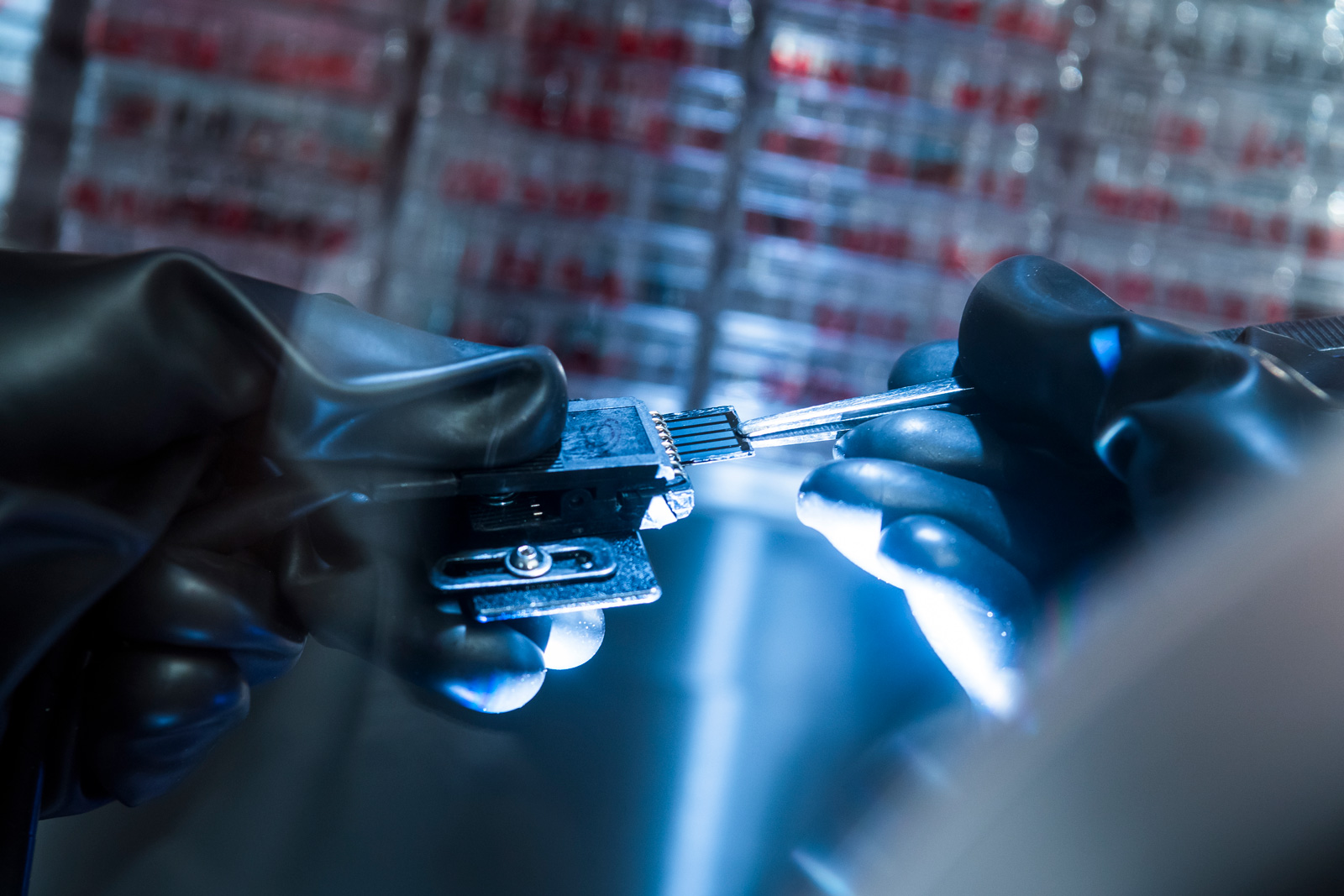 A researcher tests the function of the solar cells inside the glove box.