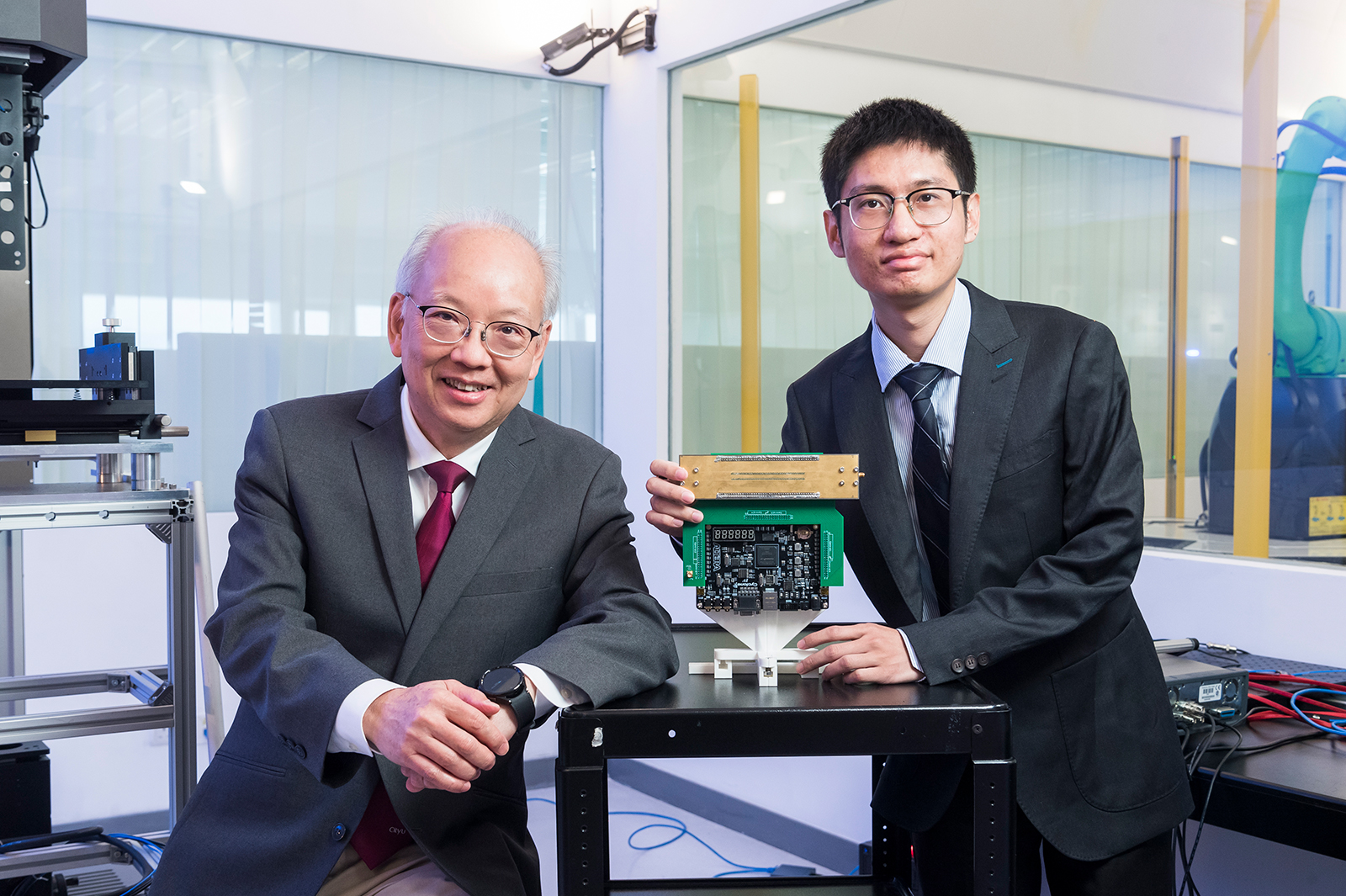 Professor Chan Chi-hou (left) and Professor Wu Gengbo (right) showcase the universal metasurface antenna developed at CityU, which allows unprecedented manipulation of electromagnetic waves