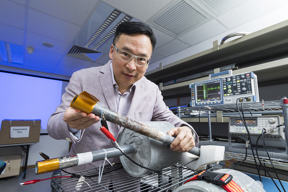 The golden sheet held by Dr Peter Tse Wai-tat is a sensor that, when wrapped around exposed parts of a pipe, identifies corrosion in parts of a pipe that are covered.