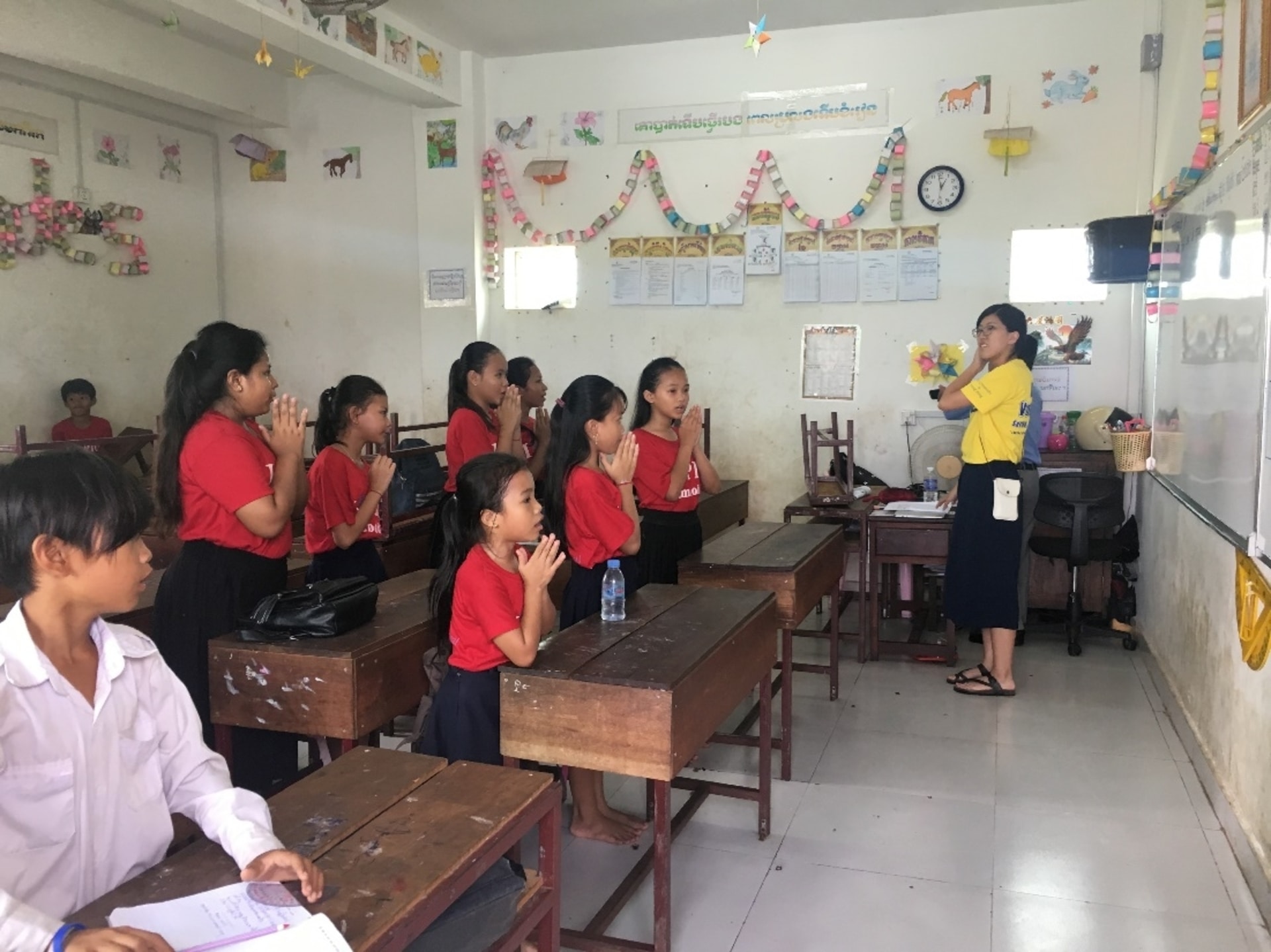 Students from a grade five class were greeting our volunteer with Cambodians traditional greeting ge