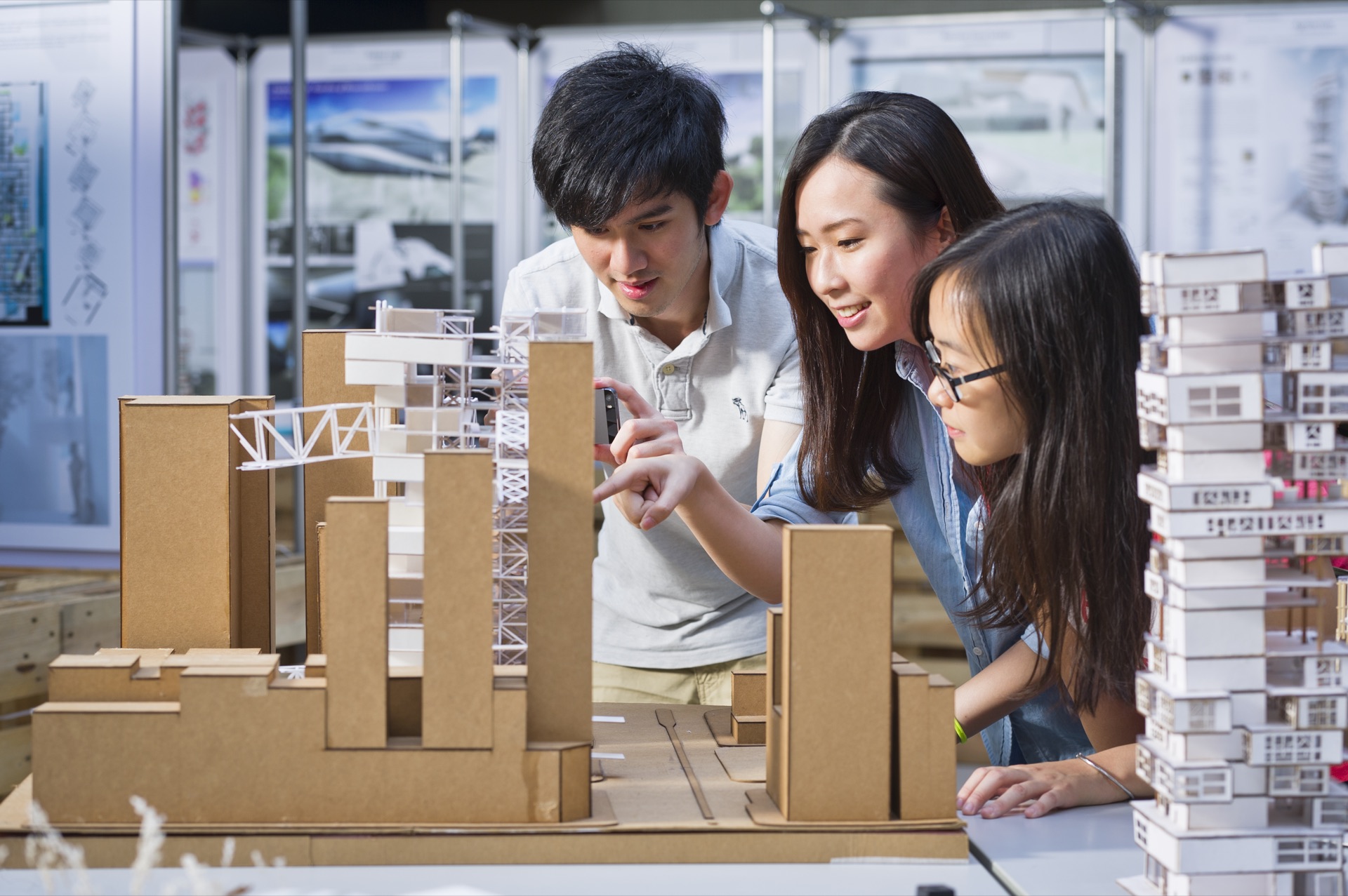 CityUHK students examining architectural models in a design studio