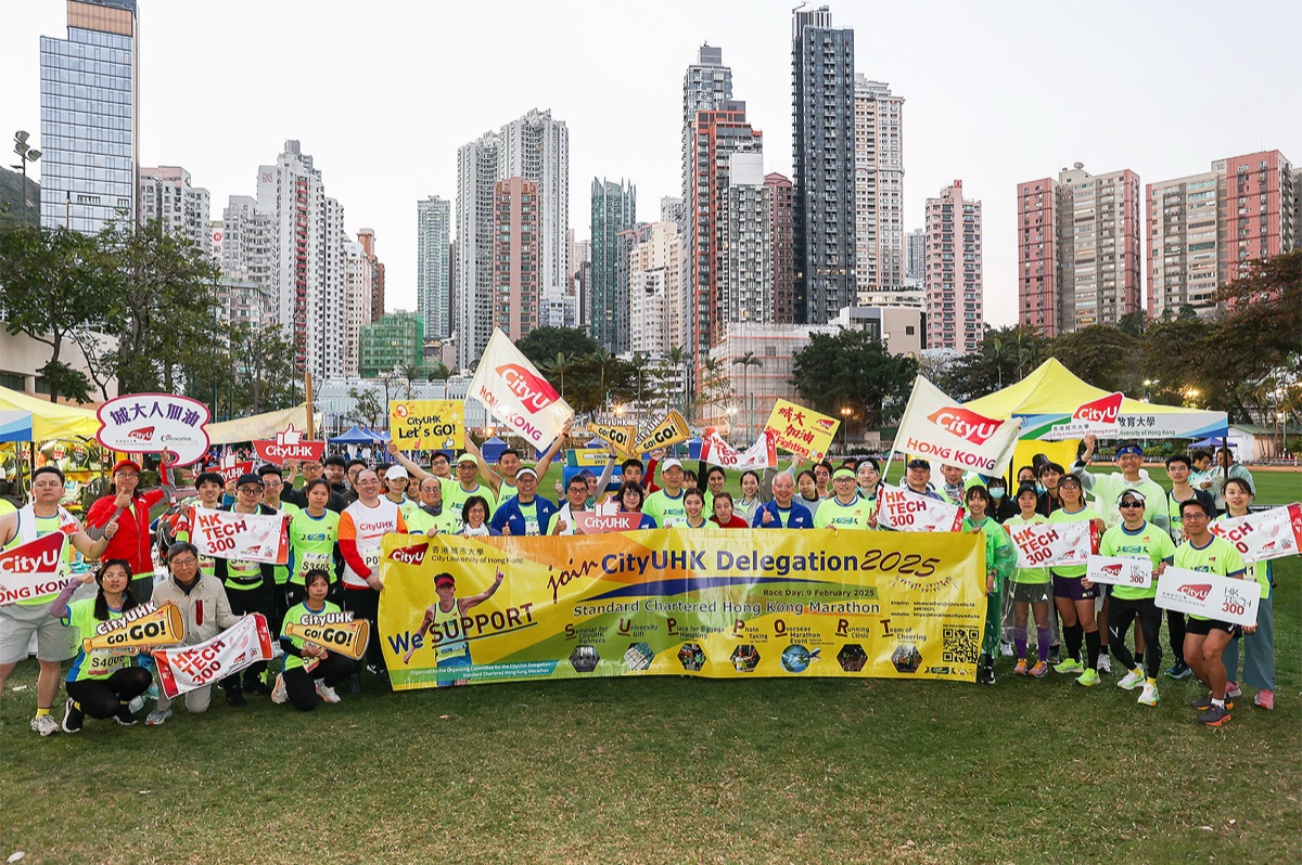 CityUHK runners behind a "CityUHK Delegation 2025" banner before the Standard Chartered Hong Kong Marathon
