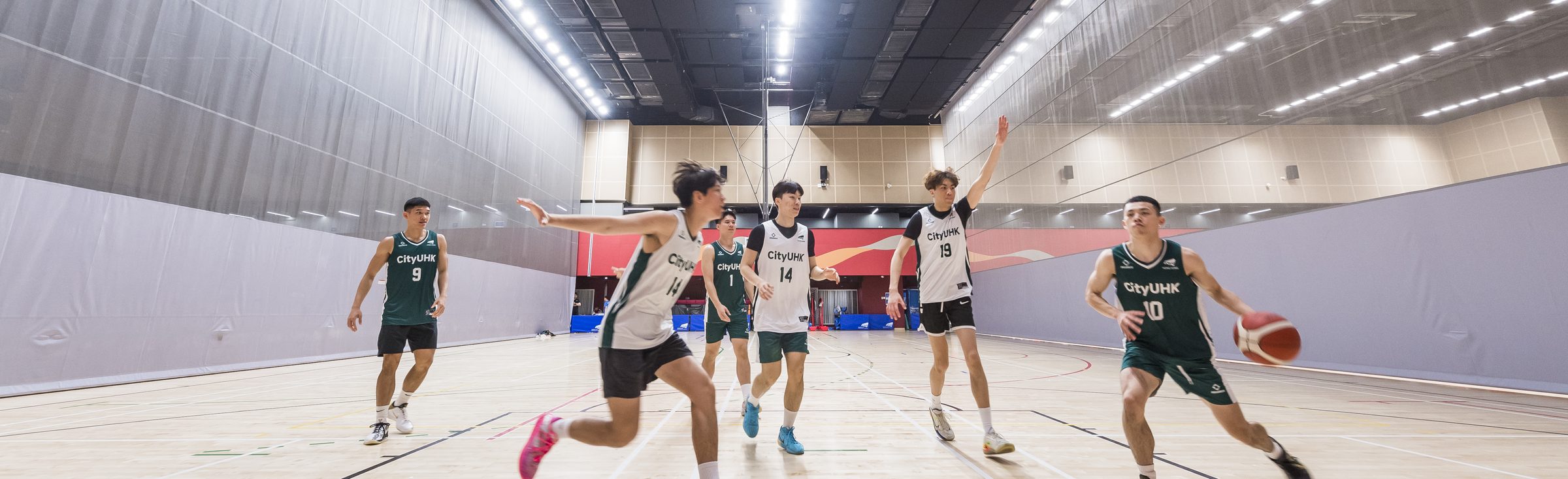 CityUHK students playing basketball in the Hu Fa Kuang Sports Centre