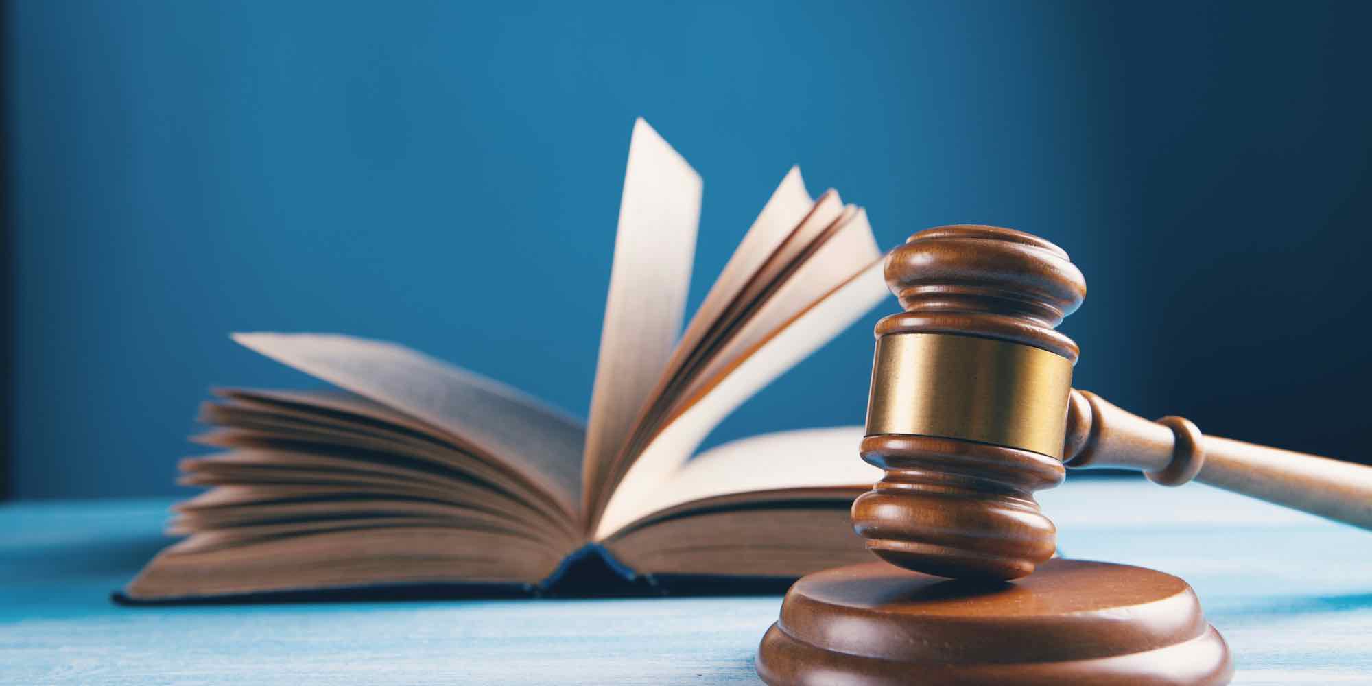 A judge's gavel resting beside an open law book