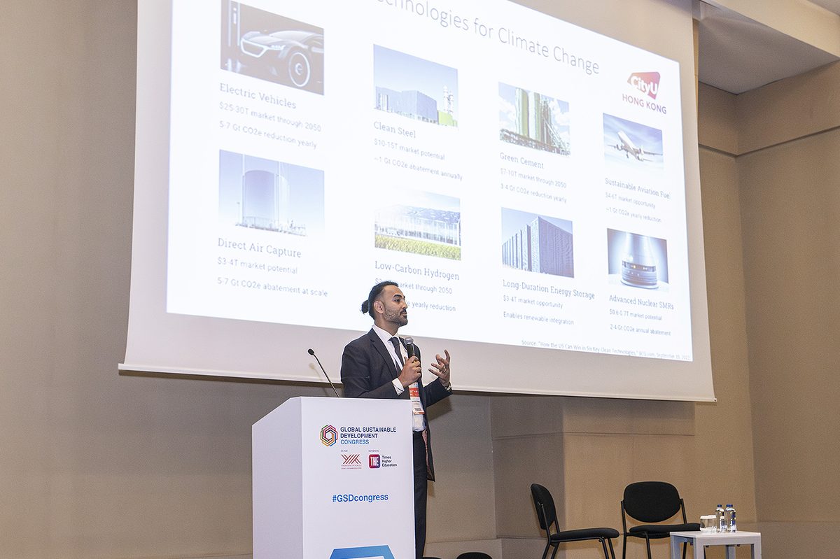 A CityUHK speaker at the Global Sustainable Development Congress lectern, presenting a slide headed "Technologies for Climate Change"