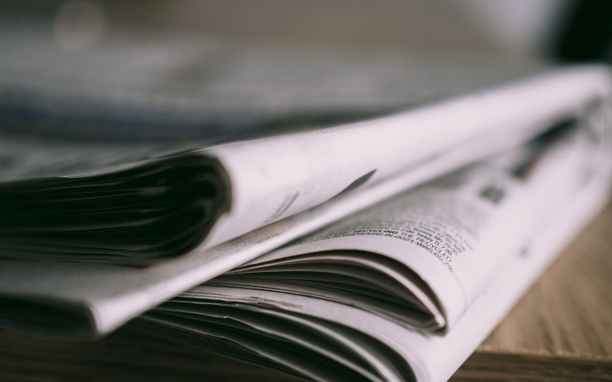 A folded printed publication lying on a desk